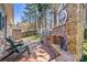 Outdoor fireplace with a grill on brick patio and wooden fence at 7331 Sedgebrook W Dr, Stanley, NC 28164