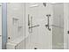 Contemporary shower featuring glass doors, bench seat, and decorative tile work at 7331 Sedgebrook W Dr, Stanley, NC 28164