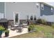 Charming backyard features a patio seating area, grill, and manicured lawn space at 7456 Hartsfield Dr, Lancaster, SC 29720