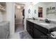 Bathroom featuring double sinks with granite countertop and entry to the closet at 7456 Hartsfield Dr, Lancaster, SC 29720