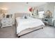 Bright bedroom featuring a beige upholstered bed, stylish furnishings, and a light gray carpet at 7456 Hartsfield Dr, Lancaster, SC 29720