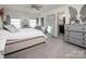 Spacious bedroom with a large mirror, gray dresser, and an ensuite bathroom at 7456 Hartsfield Dr, Lancaster, SC 29720