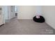 Spacious bonus room featuring neutral carpet, fresh paint, and a comfy beanbag chair at 7456 Hartsfield Dr, Lancaster, SC 29720