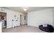 Bright bonus room featuring neutral paint, carpeted floor, accent furniture, and access to laundry area at 7456 Hartsfield Dr, Lancaster, SC 29720