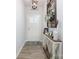 Bright hallway with a decorative table, art, and wood-look flooring at 7456 Hartsfield Dr, Lancaster, SC 29720