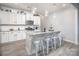 Spacious kitchen featuring a large island with seating, granite countertops and modern appliances at 7456 Hartsfield Dr, Lancaster, SC 29720