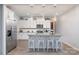 Bright kitchen with white cabinets, stainless steel appliances, and island with barstool seating at 7456 Hartsfield Dr, Lancaster, SC 29720