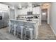 Open kitchen featuring a granite island with seating, stainless appliances, and white cabinetry at 7456 Hartsfield Dr, Lancaster, SC 29720