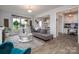 Inviting living room with hardwood floors, a gray sofa, and a view into the kitchen and dining areas at 7456 Hartsfield Dr, Lancaster, SC 29720