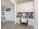 Functional home office features built-in cabinets, a granite countertop desk, and a comfortable swivel chair at 7456 Hartsfield Dr, Lancaster, SC 29720