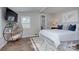 Neutral bedroom featuring a decorative shelf, soft white comforter, and natural light from the large window at 7611 Buckland Rd, Charlotte, NC 28278