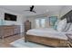Bedroom featuring hardwood floors, a ceiling fan, and balcony access through French doors at 7611 Buckland Rd, Charlotte, NC 28278