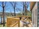 Outdoor deck overlooking lake, with seating and a wood railing at 7611 Buckland Rd, Charlotte, NC 28278