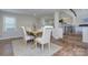 Well-lit dining area with a rustic table, neutral chairs, and easy access to the kitchen at 7611 Buckland Rd, Charlotte, NC 28278