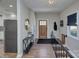 Bright foyer with wood floors, a decorative front door, and convenient coat storage at 7611 Buckland Rd, Charlotte, NC 28278