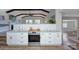 Well-lit kitchen with white cabinetry, stainless steel oven, and gray countertops providing a stylish cooking space at 7611 Buckland Rd, Charlotte, NC 28278