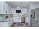 Modern kitchen features white cabinets, stainless steel appliances, and a farmhouse sink at 7611 Buckland Rd, Charlotte, NC 28278