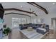 Spacious living room featuring vaulted ceilings, exposed beams, lake views, and a comfortable seating area at 7611 Buckland Rd, Charlotte, NC 28278