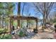 Inviting outdoor patio with lake views, pergola, grill, and cozy seating area perfect for relaxing at 7611 Buckland Rd, Charlotte, NC 28278