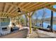 Lakeside patio featuring comfortable seating under a charming wooden pergola, ideal for outdoor relaxation at 7611 Buckland Rd, Charlotte, NC 28278