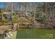 Stunning rear exterior view shows multi-level decks, leading to a private dock and lake access for waterfront enjoyment at 7611 Buckland Rd, Charlotte, NC 28278