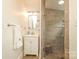Contemporary bathroom with glass enclosed shower, vanity with storage and neutral tile at 7794 Live Oaks Dr, Denver, NC 28037