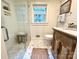 Cozy bathroom with white marble tile, a glass enclosed shower with a built-in bench and vintage style vanity at 7794 Live Oaks Dr, Denver, NC 28037
