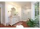 Bright bathroom with marble countertops, white cabinets, glass enclosed shower and wood floors at 7794 Live Oaks Dr, Denver, NC 28037