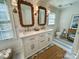 Charming bathroom featuring double sink vanity with decorative mirrors and nautical-themed blue and white tiling at 7794 Live Oaks Dr, Denver, NC 28037