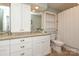 Bright bathroom featuring a double vanity with granite countertop and tiled floor at 7794 Live Oaks Dr, Denver, NC 28037