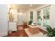 Bright bathroom features a glass enclosed shower, white wainscoting, and access to the outdoors at 7794 Live Oaks Dr, Denver, NC 28037