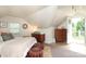 Bedroom with neutral colors, balcony access and cozy ottomans and a three-drawer mid-century modern bureau at 7794 Live Oaks Dr, Denver, NC 28037