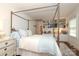 Bedroom with a four poster bed, light blue accents, built-in bookcase and drawers at 7794 Live Oaks Dr, Denver, NC 28037