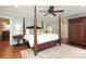 Spacious bedroom with four-poster bed, hardwood floors, and ample natural light at 7794 Live Oaks Dr, Denver, NC 28037