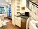 Chic butler's pantry area near stairway with beverage center, custom cabinet, and convenient access to kitchen at 7794 Live Oaks Dr, Denver, NC 28037