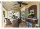 Comfortable outdoor dining space on covered porch, featuring flagstone and well-appointed decor at 7794 Live Oaks Dr, Denver, NC 28037