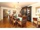 Elegant dining room featuring a chandelier, dark wood table and hutch, and hardwood floors at 7794 Live Oaks Dr, Denver, NC 28037