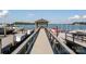 Long dock featuring covered seating, boat slips, and picturesque views of the surrounding lake at 7794 Live Oaks Dr, Denver, NC 28037