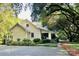 Quaint home surrounded by mature trees and lush landscaping, adding to its charm and curb appeal at 7794 Live Oaks Dr, Denver, NC 28037