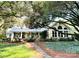 Charming home with a inviting front porch, lush landscaping, and mature trees, providing shade and beauty at 7794 Live Oaks Dr, Denver, NC 28037