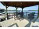 Relaxing gazebo overlooking the water with ample seating, ideal for outdoor entertaining at 7794 Live Oaks Dr, Denver, NC 28037