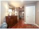 Inviting hallway with hardwood floors, accent furniture, and neutral wall paint at 7794 Live Oaks Dr, Denver, NC 28037