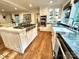 Well-equipped kitchen with a large island, stainless steel appliances, and hardwood floors, perfect for cooking and entertaining at 7794 Live Oaks Dr, Denver, NC 28037
