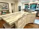 Elegant kitchen featuring a marble island with seating, custom cabinetry, and modern appliances at 7794 Live Oaks Dr, Denver, NC 28037