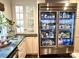 Gourmet kitchen with glass-front refrigerator, ample cabinetry, and stylish countertops, creating an elegant and functional workspace at 7794 Live Oaks Dr, Denver, NC 28037