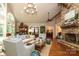 Open-concept living room with stone fireplace and seamless flow to the dining area at 7794 Live Oaks Dr, Denver, NC 28037