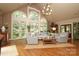 Bright living room featuring large windows, hardwood floors, and comfortable seating at 7794 Live Oaks Dr, Denver, NC 28037