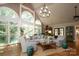 Bright and airy living room with large windows, a vaulted ceiling, and hardwood floors at 7794 Live Oaks Dr, Denver, NC 28037