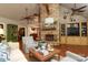 Spacious living room with a stone fireplace, high ceilings, and an open floor plan at 7794 Live Oaks Dr, Denver, NC 28037