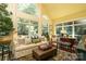 Cozy living room with large windows offering ample natural light and verdant outdoor views at 7794 Live Oaks Dr, Denver, NC 28037